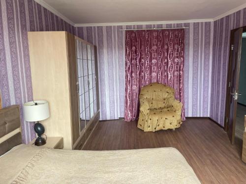a bedroom with a bed and a chair in it at wine valley in Udabno