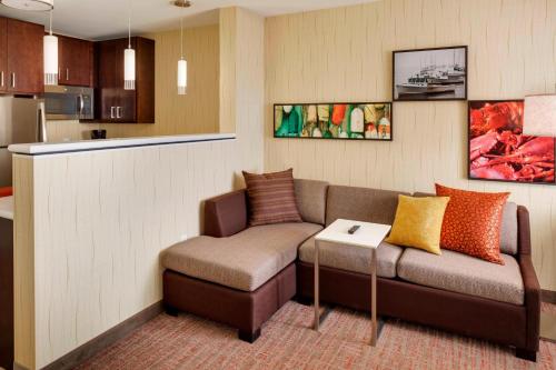 a living room with a couch and a table at Residence Inn by Marriott Bath Brunswick Area in Bath