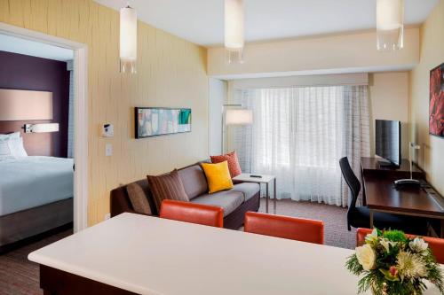 a hotel room with a bed and a living room at Residence Inn by Marriott Bath Brunswick Area in Bath