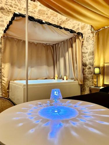 a table with a wine glass on top of a bed at La Maison Arco Boccolicchio in Manfredonia