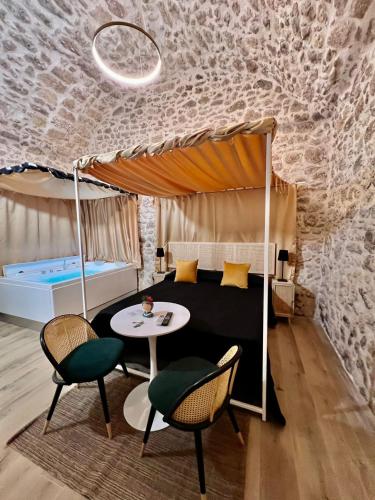 a bedroom with a bed with a table and chairs at La Maison Arco Boccolicchio in Manfredonia
