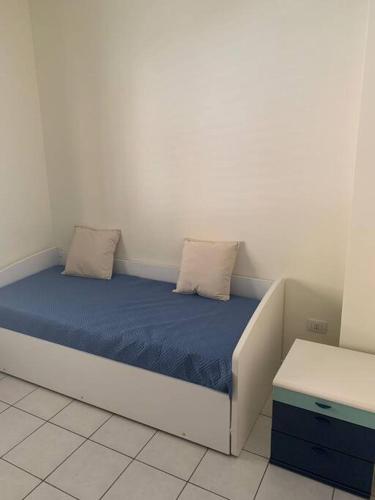 a bed with two pillows on it in a room at Casa Fanù in Licata