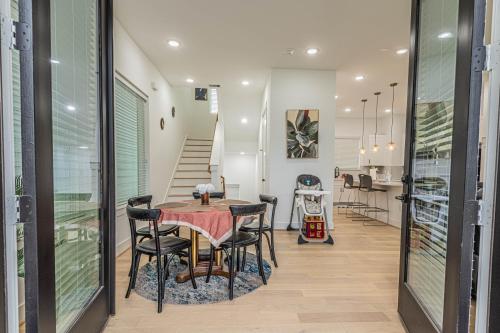 a dining room with a table and chairs and a staircase at Cozy Duplex Mins to DT/ MCTR, free wi-fi/ Parking in Houston