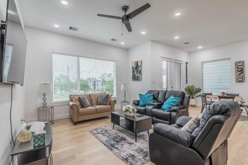 a living room with couches and a ceiling fan at Cozy Duplex Mins to DT/ MCTR, free wi-fi/ Parking in Houston