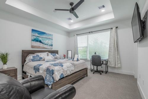 a bedroom with a bed and a chair and a window at Cozy Duplex Mins to DT/ MCTR, free wi-fi/ Parking in Houston