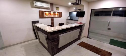 a bathroom with a sink and a shower in a room at Hotel Orange in Vapi