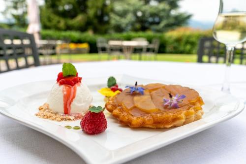 a plate with two pastries and strawberries on a table at La Corte di Lurago in Lurago D'Erba 