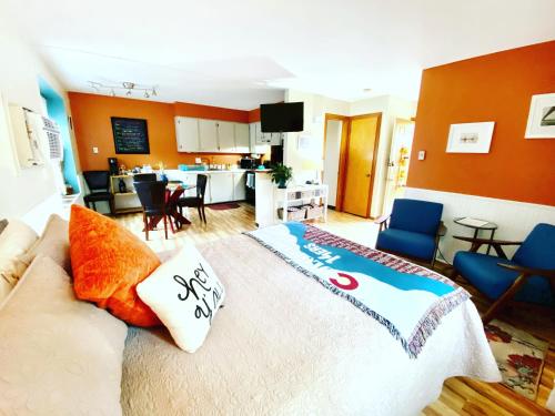 a living room with a bed and a kitchen at Remington Flats in Fort Collins