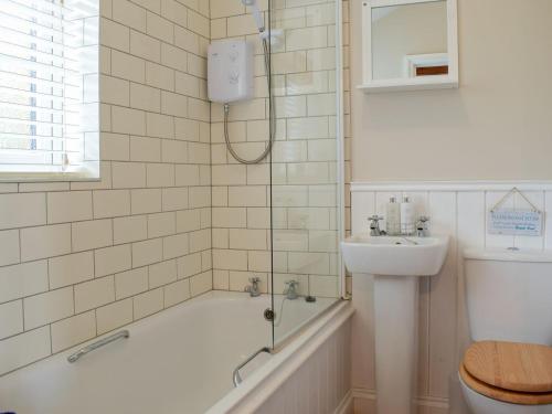 a bathroom with a tub and a sink and a shower at Lodge 2 in Kinlet