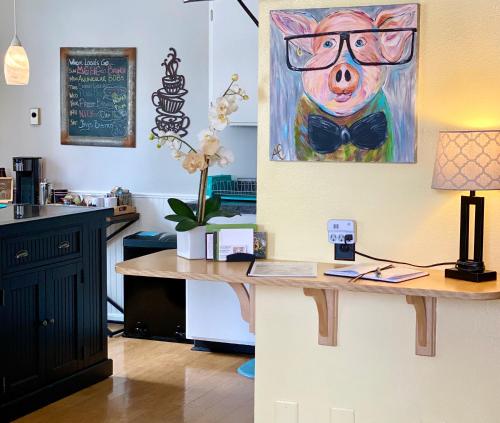 a desk with a painting of a pig wearing a bow tie at Remington Flats in Fort Collins