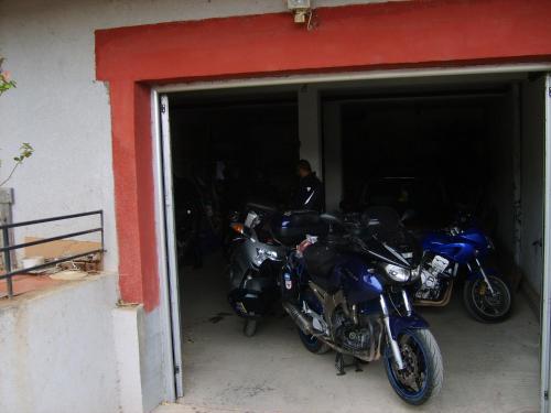 a couple of motorcycles parked in a garage at Smeštaj - sobe MARVEL in Niš
