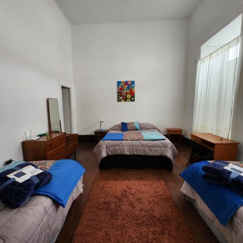 a bedroom with two beds and a window at Casa Portal Del Valle in La Serena