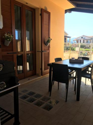 a dining room table and chairs in a patio at Domu Bonora in Pula