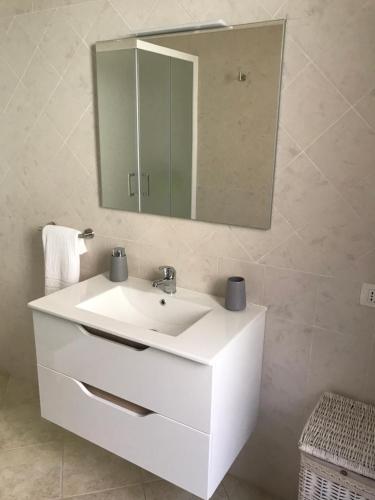 a bathroom with a white sink and a mirror at Domu Bonora in Pula