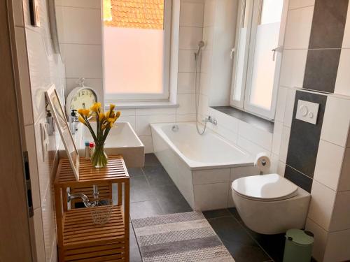 a bathroom with a tub and a toilet and a sink at Apartment Stadtmauer in Bürgel
