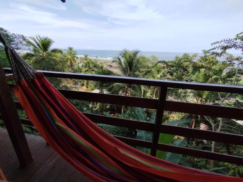 a hammock on a balcony with a view of the beach at Cabaña Casa Cielo in El Valle