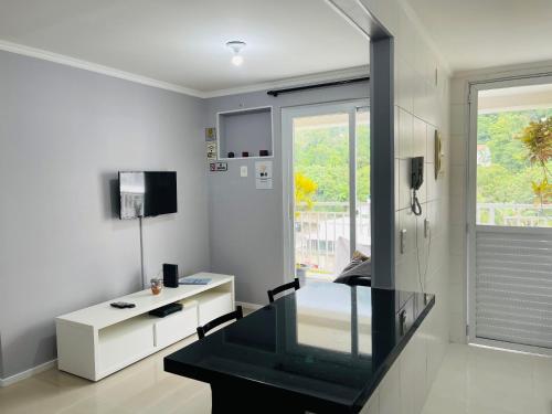 a room with a glass desk and a window at Suites W-Riocentro in Rio de Janeiro