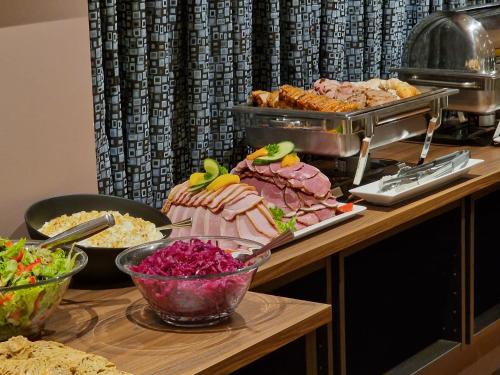 a buffet with different types of food on a table at Hótel Bifröst in Bifrost