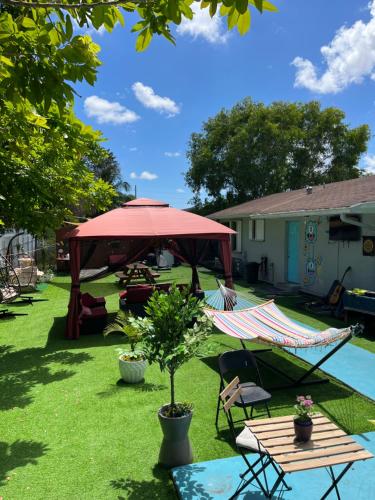 a patio with a red canopy and a table and chairs at Art Graffiti in Miami