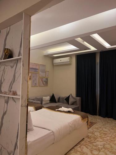 a bedroom with a bed and a couch at Pyramids top success result in Cairo