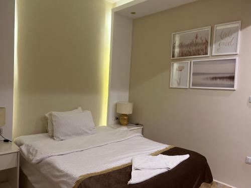 a small bedroom with a bed with a mirror at Pyramids top success result in Cairo