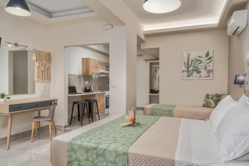 een hotelkamer met 2 bedden en een keuken bij Rania's Deluxe Studios in Tsilivi