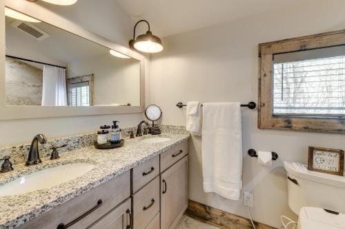 a bathroom with a sink and a mirror at Cottage with Screened Porch and Trails Near Cashiers! in Glenville