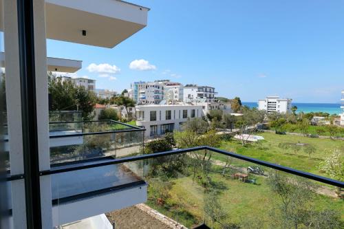 a balcony with a view of a city and the ocean at Hotel ABA in Ksamil
