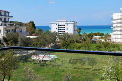 a view from a balcony of a city with the ocean at Hotel ABA in Ksamil