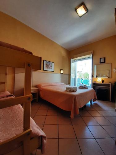 a bedroom with a bed and a large window at Hotel Originale by ALEhotels in Rimini