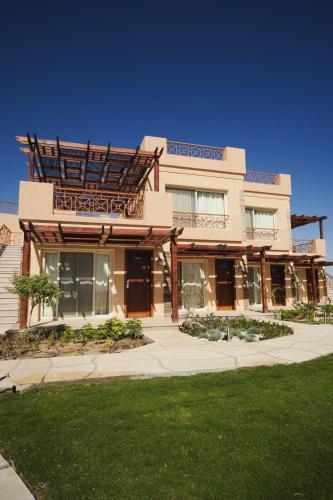 a building with a sign on top of it at Shams Prestige Abu Soma (Adults Only) in Hurghada