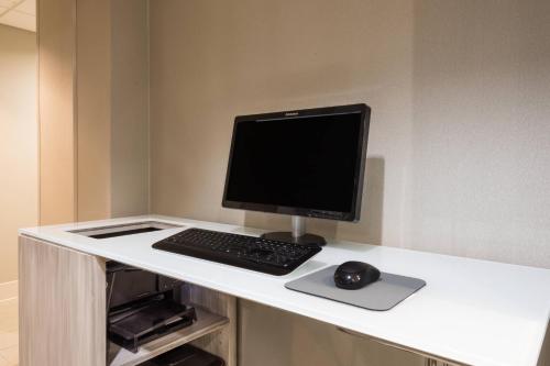 a computer monitor and a mouse on a desk at Residence Inn Brownsville in Brownsville