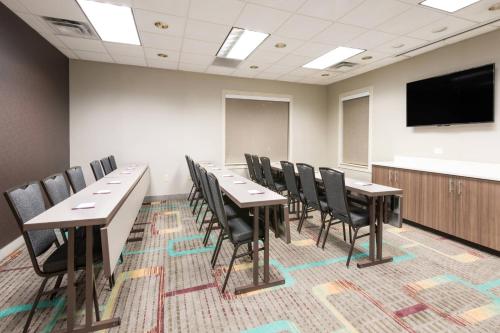 a conference room with tables and chairs and a flat screen tv at Residence Inn Brownsville in Brownsville