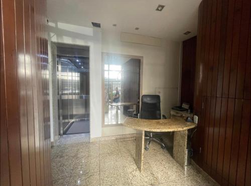 an office with a desk and a chair in a room at Suíte privada no melhor do Leblon in Rio de Janeiro