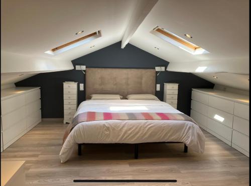 a bedroom with a large bed in a attic at Maison de charme - Sospel in Sospel
