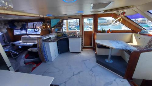 an inside view of a kitchen and living room on a boat at COZY CONDO OCEAN 3xDECK YACHT in Brooklyn