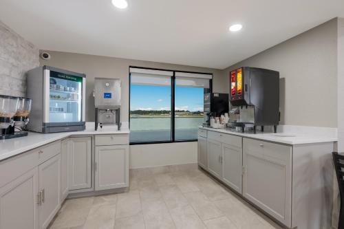 a large kitchen with a large window and a television at Quality Inn Gadsden - Attalla in Gadsden