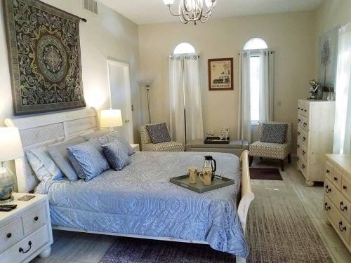 a bedroom with a blue bed with a tray on it at Tuscan Manor in Eureka Springs