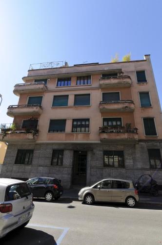 a tall building with cars parked in front of it at Casatitta Bed & Breakfast in Milan