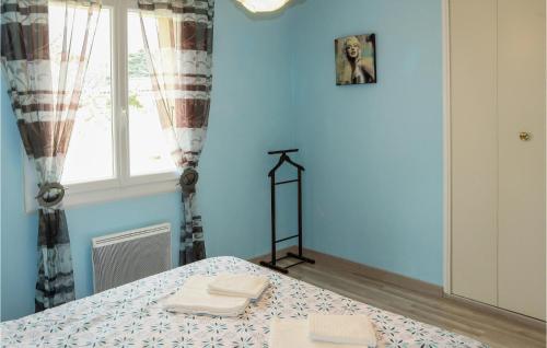 a blue room with a table and a window at Awesome Home In Pierrelatte With Wifi in Saint-Just-la-Pendue