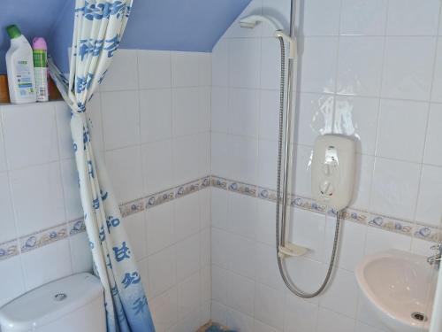 a bathroom with a shower and a sink at Hawthorne Cottage in Preston