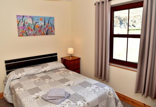 a bedroom with a bed and a window at Sea View Apartment in Downings