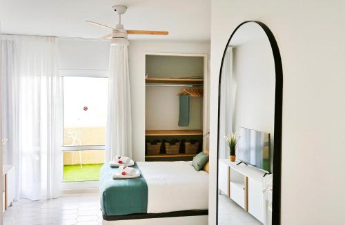 a bedroom with a bed and a mirror at ESTRENO Benalbeach vistas al mar Estudio DELUXE in Benalmádena