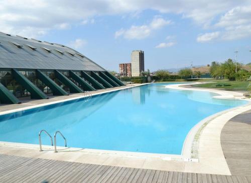 a large swimming pool in front of a building at Bursa Dream Apartment in Bursa