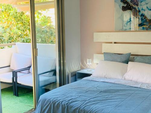 a bedroom with a bed and a glass window at Butterfly-Palais des Festival-center-quiet-AC-Wi Fi parking in Cannes