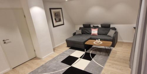 a living room with a couch and a table at Renatas Ferienwohnung Sasbachwalden in Sasbachwalden