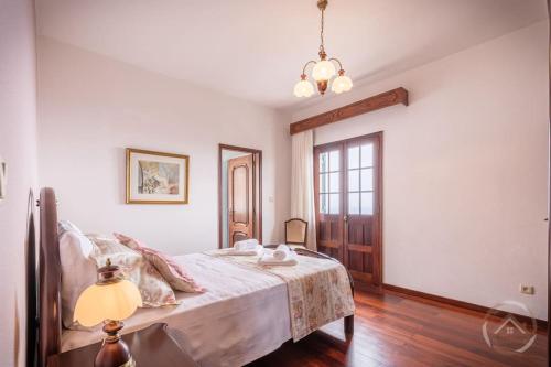 a bedroom with a bed and a lamp in it at Garden House in Funchal