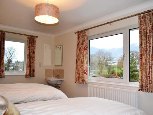 a bedroom with two beds and a window at Gatesgarth in Keswick