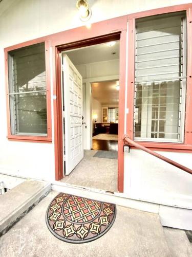 a front door of a house with an open door at YOUR HILO HOMEBASE - Lovely 3 Bedroom in Heart of Hilo with AC! in Hilo