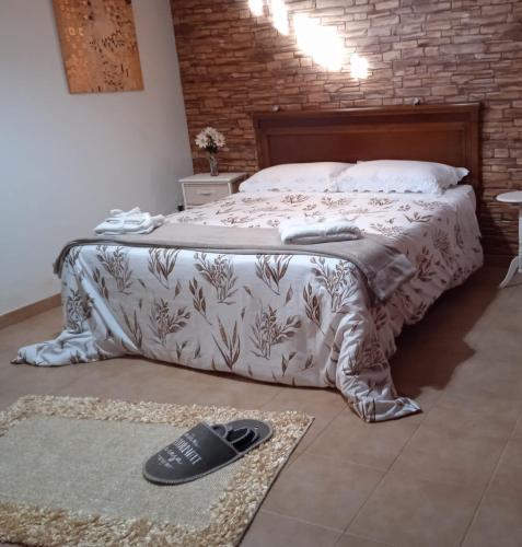 a bedroom with a bed with a blanket on the floor at Oro&Mattia's House in Trapani